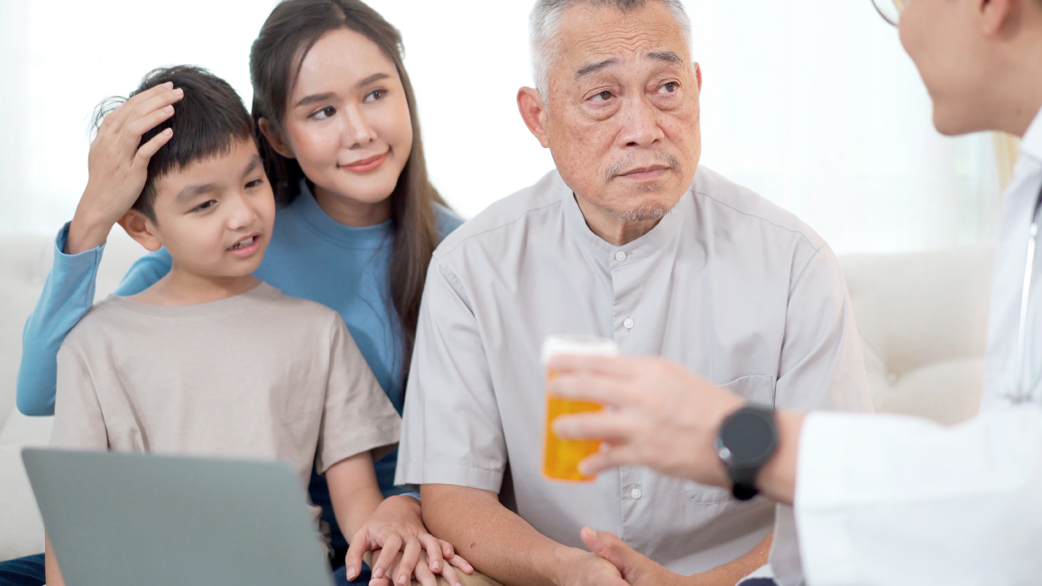 A man sees a doctor accompanied by his family