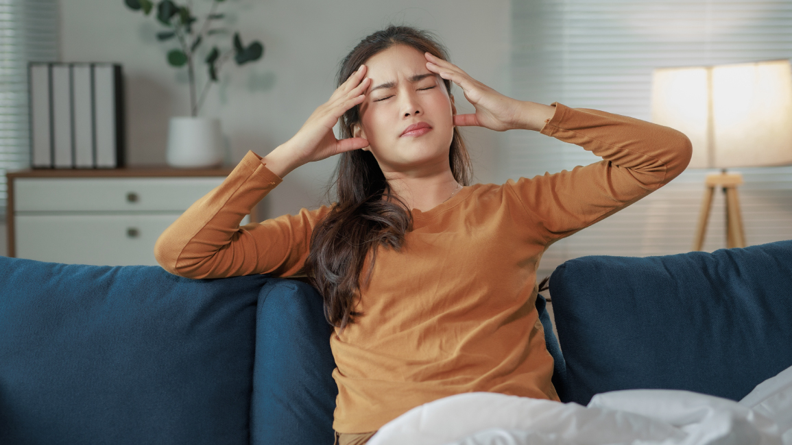 An Asian woman having a migraine. There are different types of headaches and migraines to know.
